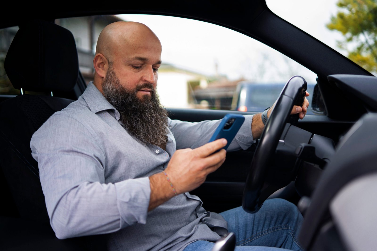 side view man holding smartphone car scaled